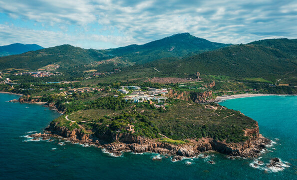 Aerial view of Capo Raisigerbi on Sicily's north coast, with Spiaggia Torre Conca to the right and Finale in the distance to the left, rugged cliffs meet crystal turquoise Mediterranean waters