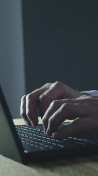 Vertical shot of business man typing on a computer. Digital business strategy creation and content. Business success