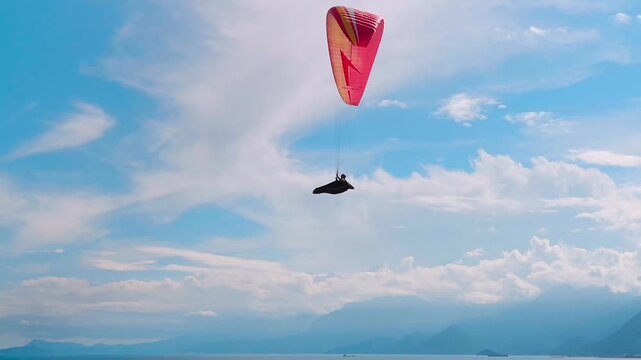 Paraglider Soaring High Under Expansive Blue Sky