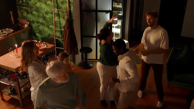 The male guest dances in the center of the circle while the family dances around him