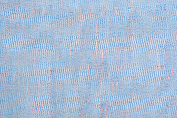 A close up shot of a blue woven fabric material with subtle orange fibers creating a detailed...