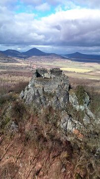 Vertical drone aerial flyover of ancient castle hill