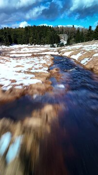 Vertical drone aerial over river in natural landscape
