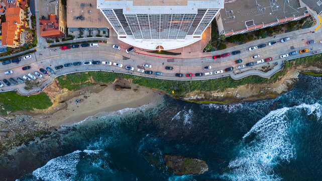 Aerial view of the dramatic contrast between the architecture and the rugged coastline, where the city meets the sea with a blend of natural and urban landscapes, San Diego, California, United States.