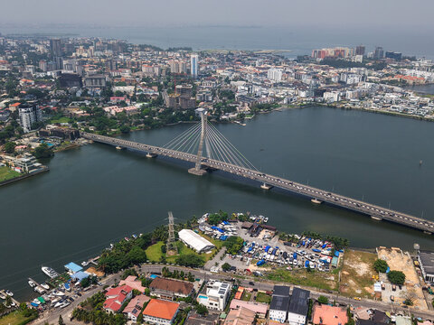 Aerial view of the Lekki-Ikoyi Link Bridge stretching across the water, connecting vibrant cityscapes under a hazy sky, Lagos, Lagos, Nigeria.