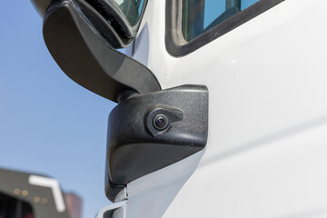 A rearview camera integrated into a truck's side mirror. Vehicle safety concept