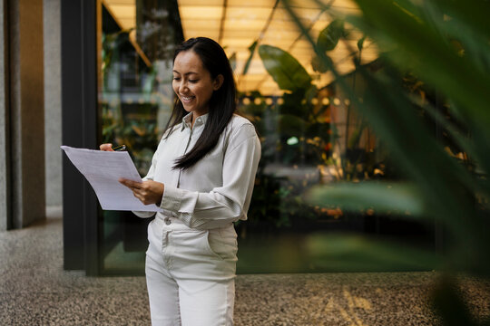 Professional reading contract and reviewing document at office