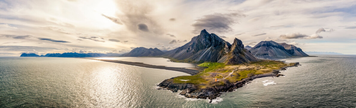 Eystrahorn mountain and Hvalnes Lighthouse on Icelandic coast drone panorama
