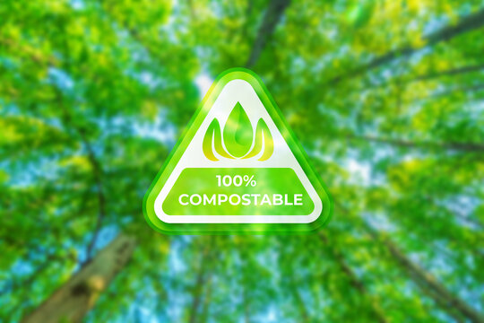 Eco-Friendly Promise: A vibrant emblem of 100% compostable shines against the backdrop of a verdant forest, embodying environmental responsibility.