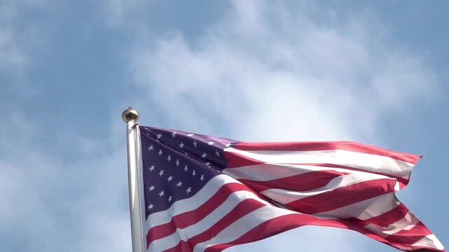 American flag waving on blue sky. United States flag. Flag in wind.. USA national symbol. Freedom and democracy. Independence day. Stars and stripes. Waving USA flag. 