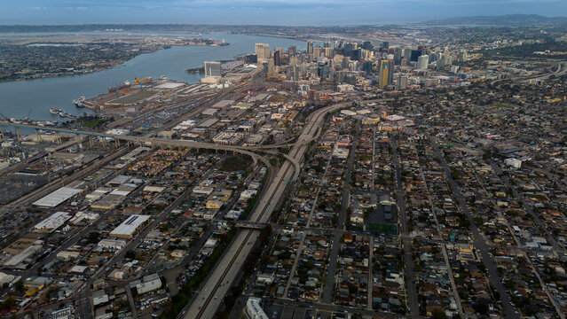 Aerial view of the city's skyline framed by the bay and sprawling urban landscape, a tapestry of modern architecture and interconnected highways, San Diego, California, United States.