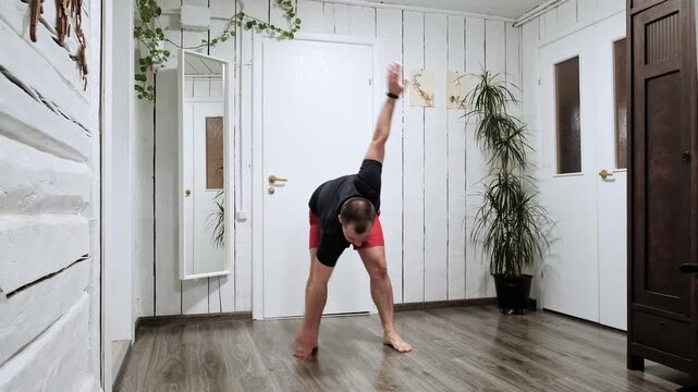 Athletic 30s man swinging arms as a windmill warming up muscles. Swings hands. Does stretching exercise. An active morning rituals. Body strengthening. Fitness workout. Helthy lifestyle concept. 4k.