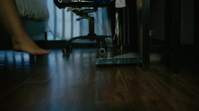 Overweight Female Checking Weight on Bathroom Scale Before Bedtime