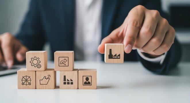 Lean manufacturing principles and removing unnecessary cubes from the layout using wooden cubes, symbolic icons, human hand, natural depth of field, soft blurred background, minimal desk background.