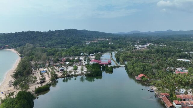 Cua Can, Phu Quoc Island, An Giang (Kien Giang) Province, Southern Vietnam &ndash; 4K aerial drone footage of winding river, coastal houses, fishing boats, village, forest in Gulf of Thailand