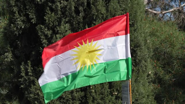 The Iraqi Kurdistan flag flutters in the wind.