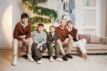 Child playing on couch in living room during daytime