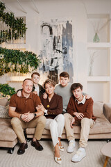 Family poses together for a photo in a modern living room setting