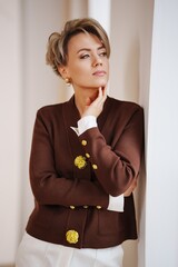 Child's hand held gently by an adult in a soft pink dress