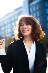 Fototapeta premium Relaxed Beautiful Businesswoman Enjoying Sunlight With Closed Eyes