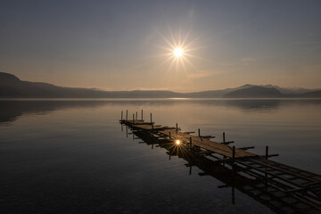 Obraz premium Morning Sun Over Pier on Lake Towada, Akita, Japan