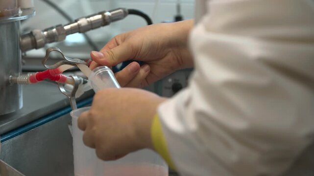 Connecting Tubes And Managing Flow. Operators Connect Tubing And Gather Samples Near Pumps Safely . Stock clip