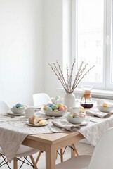 Fototapeta premium Bright dining table set with bowls of pastel eggs, coffee cups, bread and butter. Soft daylight from the window creates a clean spring holiday breakfast scene. High quality photo