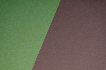 Fototapeta premium Abstract background featuring a diagonally split image of green and brown textured paper. Perfect for minimalist design,
