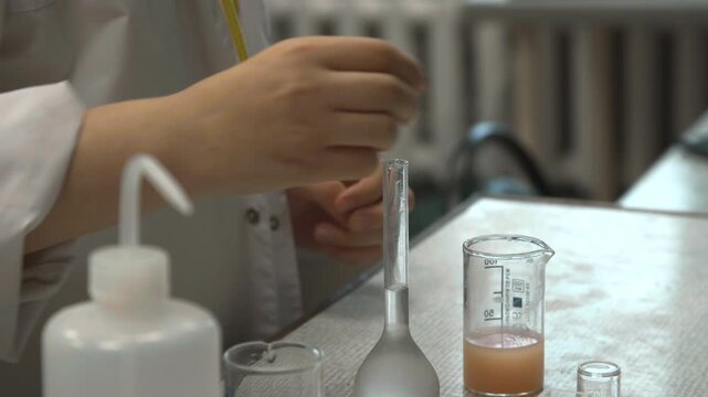 Accurate Liquid Measurement Setup. Precise Dispensing Of Liquid Into Flask During Assay Setup Process . Stock clip