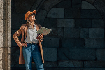 Woman traveling on the street with a map, copy-space