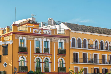 Fototapeta premium Traditional Yellow Facades and Balconies in the Macarena District, Seville, Spain