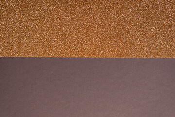 Fototapeta premium Abstract background featuring a sparkly gold glitter texture and a solid brown base. Perfect for design templates and ho