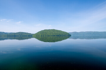 Fototapeta premium Calm Reflections of Forested Hills on Lake Towada, Aomori, Japan
