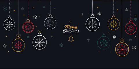Festive christmas ornaments and a merry christmas greeting on a dark background © Ramanath