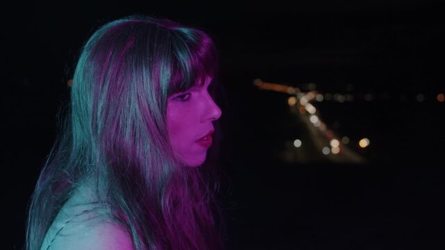 Melancholic transgender woman smoking cigarette at night