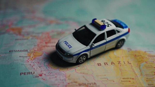 Police car model on South America map.