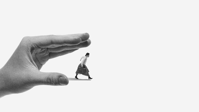 Dramatic poster oversized hand pressing standing man. Concept of remote work stress, performance tracking, productivity monitoring and algorithm based evaluation culture.