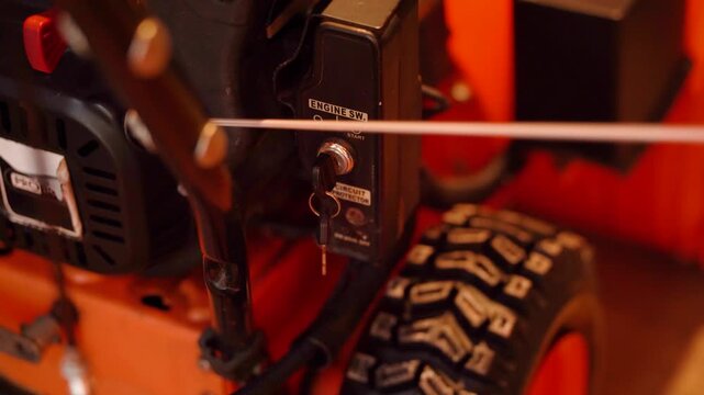 Starting a snow blower tractor by manually turning the crankshaft