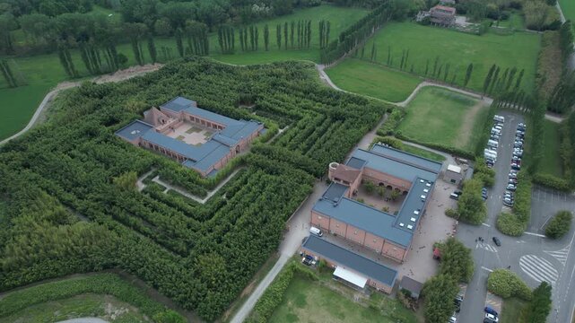 Labirinto della Masone in Fontanellato, Parma province, showing geometric bamboo maze, neoclassical courtyard museum complex and parking area within Po Valley countryside, static shot