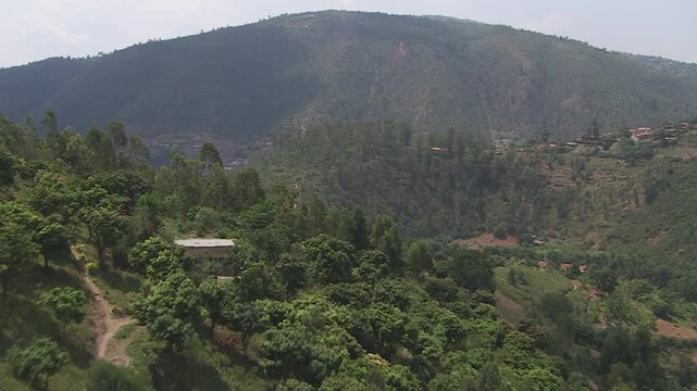 aerial view and unexpected reveal from green lush fields to the enormous city of Kigali in Africa