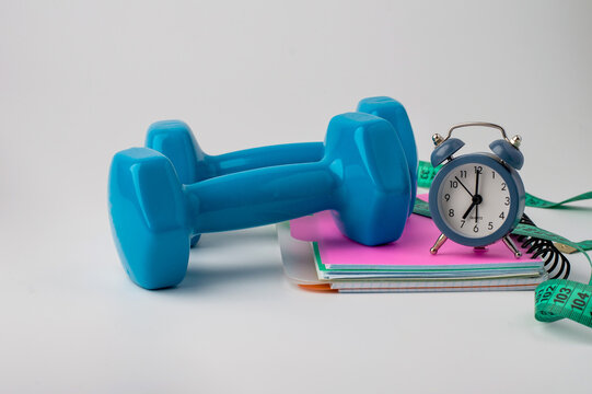Concepts for home workouts, weight control, and a healthy lifestyle. Sports equipment on a light background, horizontal.
