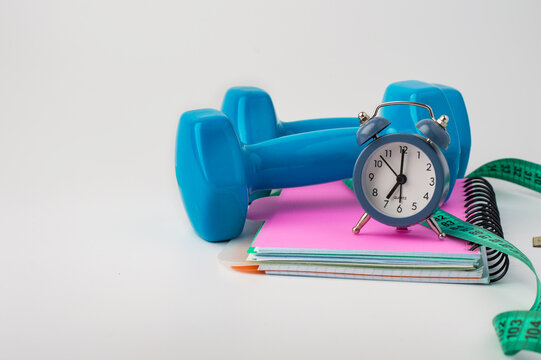 Concepts for home workouts, weight control, and a healthy lifestyle. Sports equipment on a light background, horizontal.