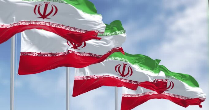 National flags of Iran waving in the wind on a clear day