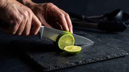 Hands slicing fresh lime for Cinco de Mayo food preparation