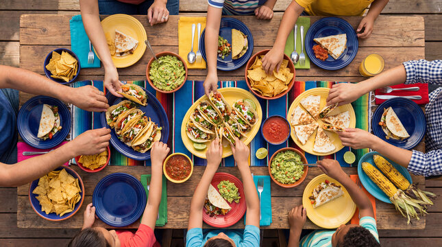 Family eating tacos and Mexican food for Cinco de Mayo celebration