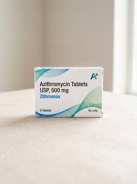 Medicine box of Azithromycin. White box with some small graphic design, light neutral background.bright, professional photo