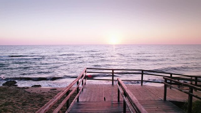 Historic Beach Stairs at Dawn: Sunrise Glow and Gentle Waves on Long Beach, Iskele, Northern Cyprus