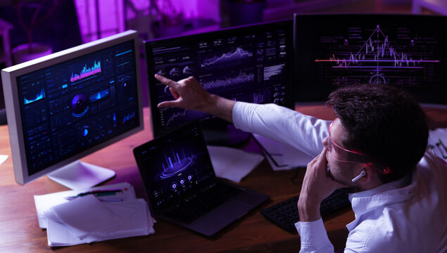 Innovative design. Business professional analyzing financial dashboards with smart glasses interface. Concept of digital transformation, market strategy and high tech enterprise systems.