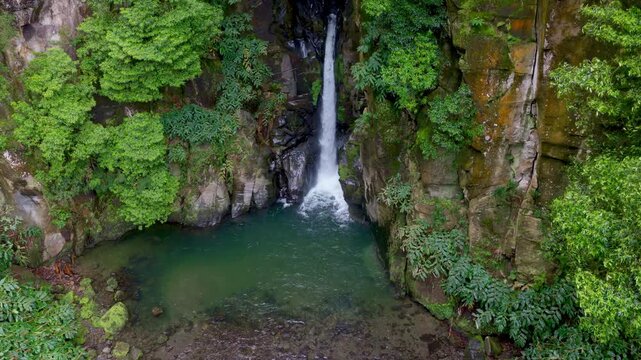 tropical waterfall on Sao Miguel in the Azores islands, drone shot of Cascata do Salta do Cabrito in Sao Miguel, hiking in the Azores, Portugal