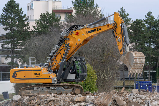 Laxou, France - December 14th 2020 : View on a yellow crawler excavator Liebherr R 940 Demolition for the demolition of a building on a construction site.